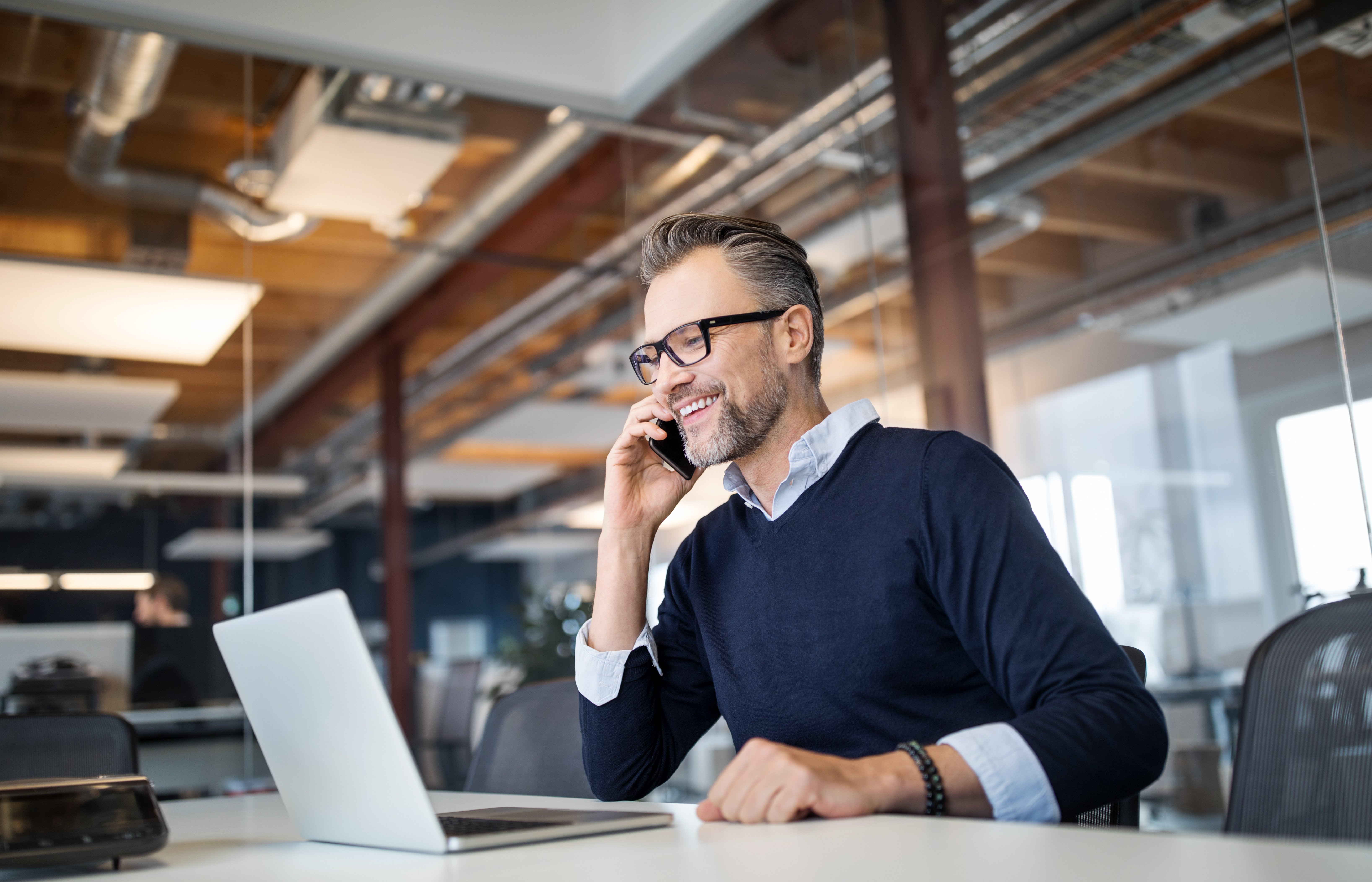 man smiling at laptop