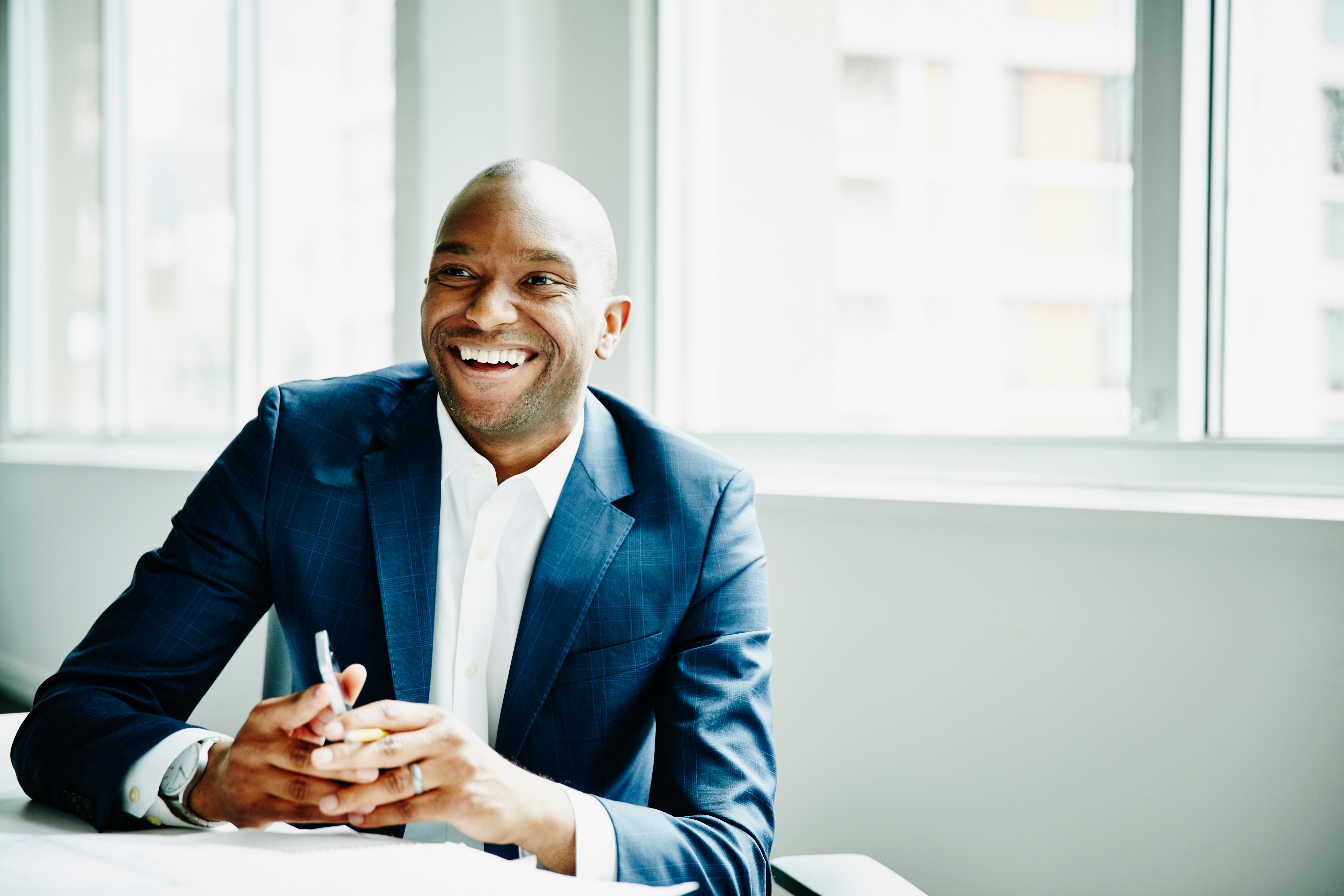 man holding phone and smiling