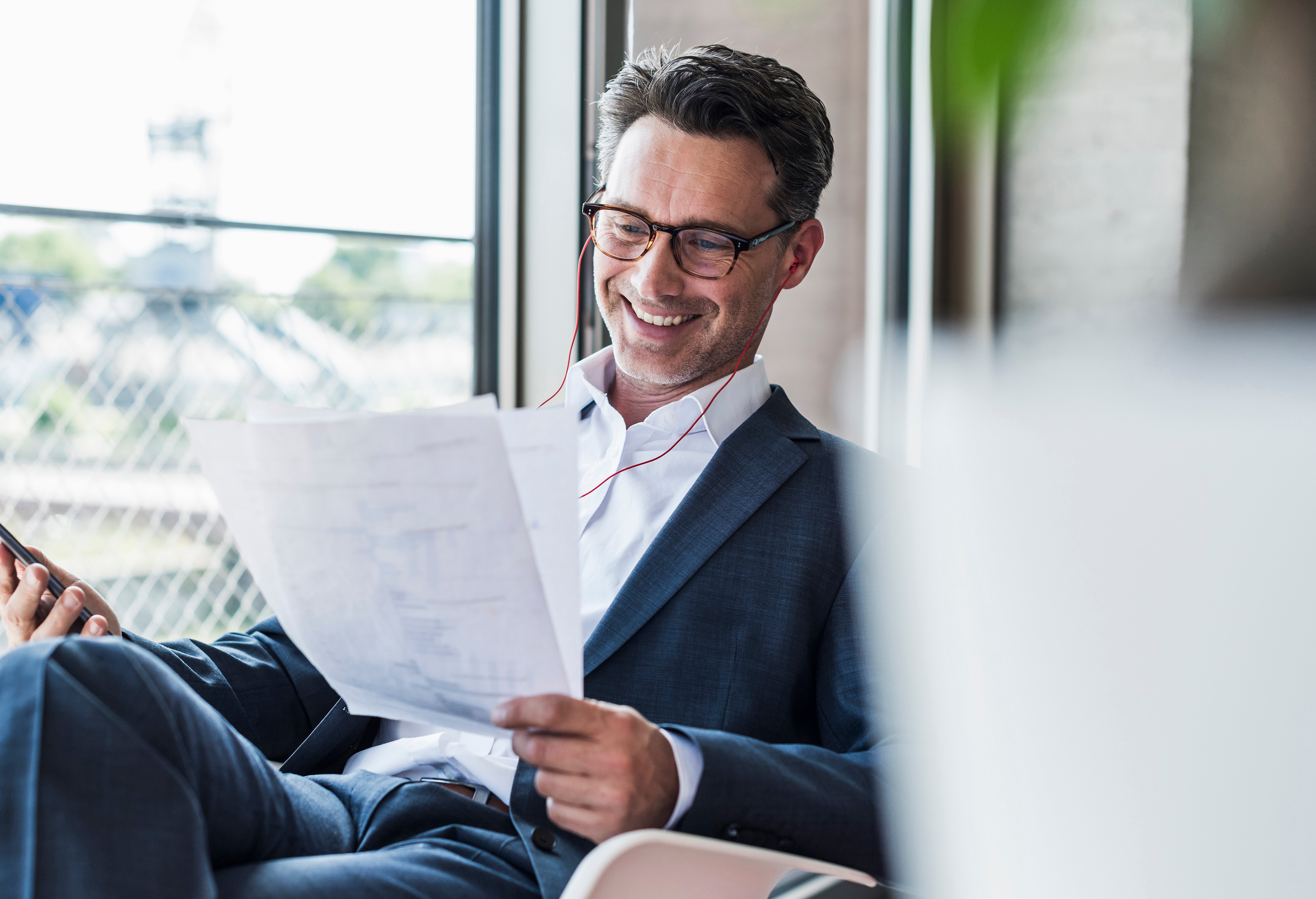 man smiling at papers