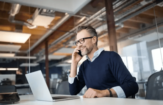 man smiling at laptop