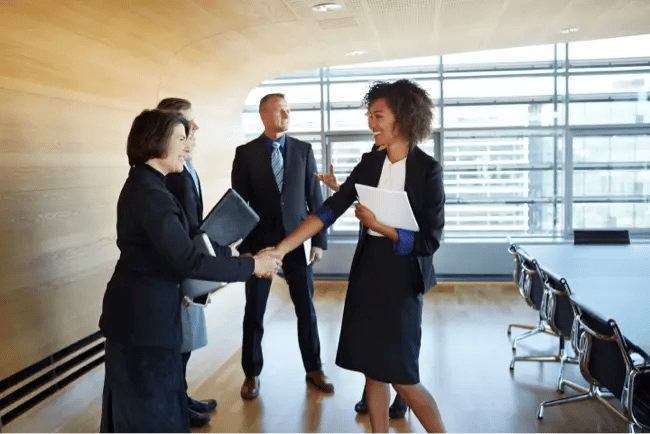 two women shaking hands