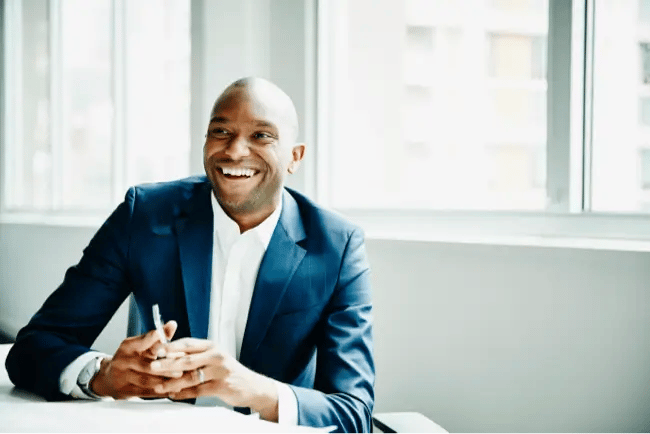 man holding phone and smiling