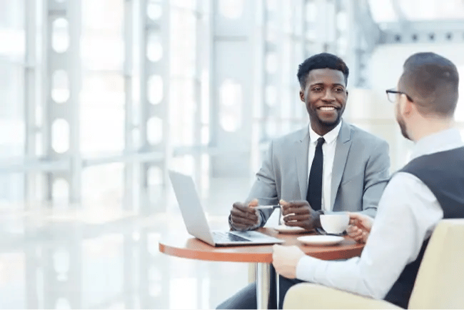 two men having coffee and talking