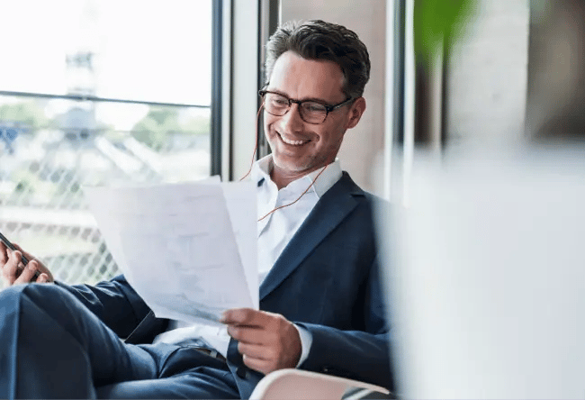 man smiling at papers