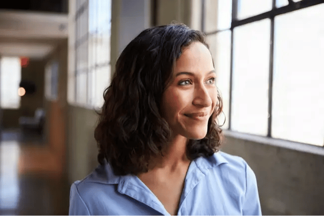 woman smiling by window