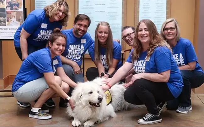 AssetMark employees with a dog