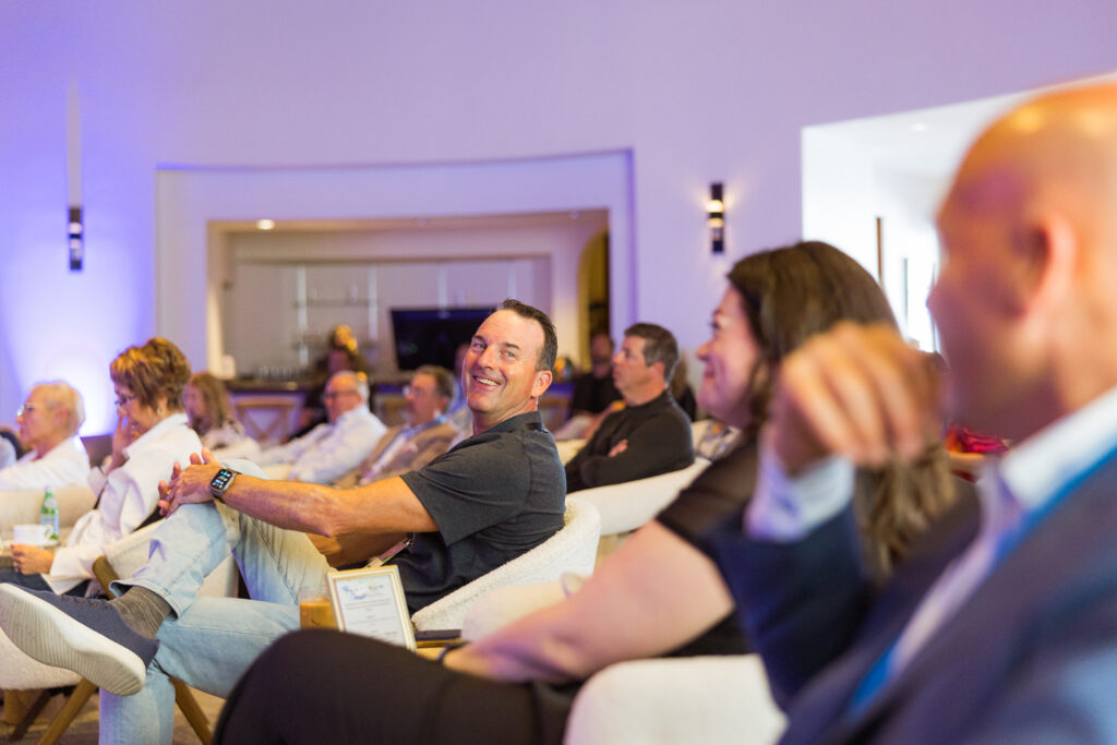 Conference attendees at a Discovery event laughing with one another