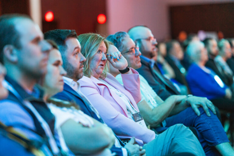 Gold Forum conference attendees listening to speaker providing insights